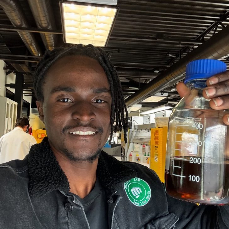 Julian Brown holding a liquid Plastoline sample in a lab setting